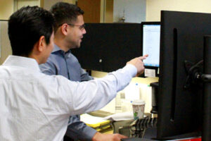 2 Employees working at a computer