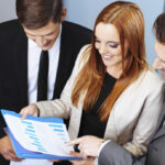 Business men and woman looking over notes