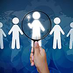 Hand hold a magnifying glass over drawn people